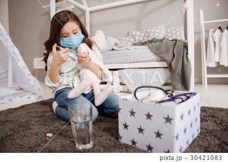 Gifted little girl curing favorite toy in the 30421083