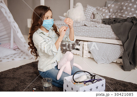 Involved girl treating toy at home 30421085