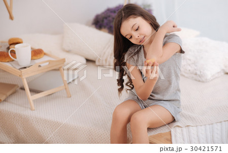 Involved little child treating her wound at home Involved little child treating her wound at home 30421571