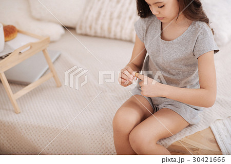 Confident child putting medical patch on the 30421666