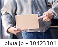 hands holding a box. 30423301
