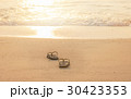 silhouette flip flop shoes on the beach in sunset  30423353