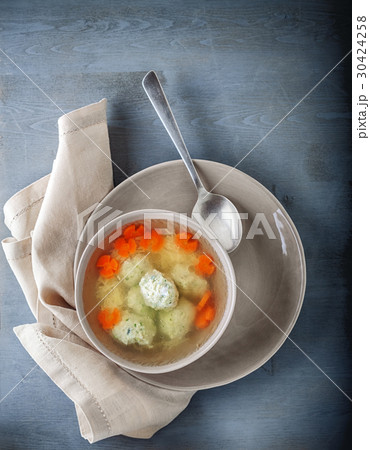 Chicken soup with meatballs and vegetables. 30424258