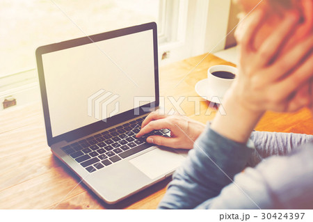 Young man using his laptop 30424397
