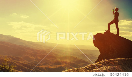 Man walking on the edge of a cliff 30424416