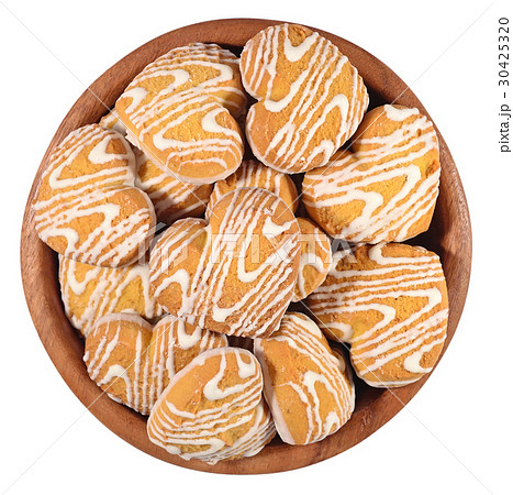 Cookies in heart shape in a wooden bowl on a white Cookies in heart shape in a wooden bowl on a white 30425320