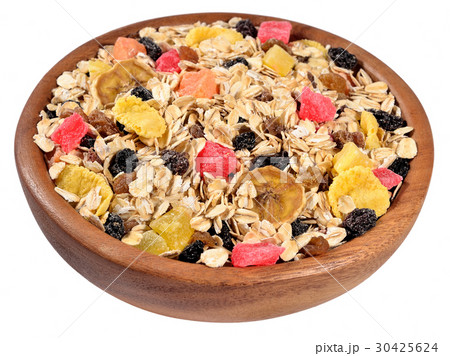 Musli in a wooden bowl on a white 30425624