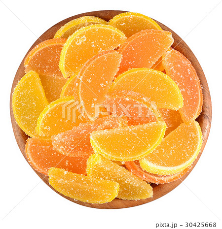 Orange and lemon candy slices in a wooden bowl 30425668