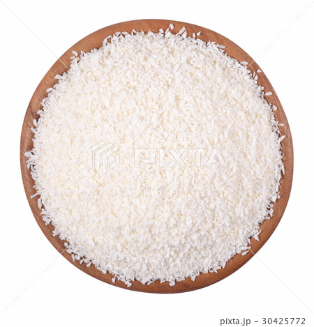 Shredded coconut in a wooden bowl on a white Shredded coconut in a wooden bowl on a white 30425772