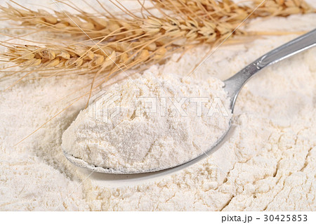 White flour in a spoon and ears of wheat White flour in a spoon and ears of wheat 30425853