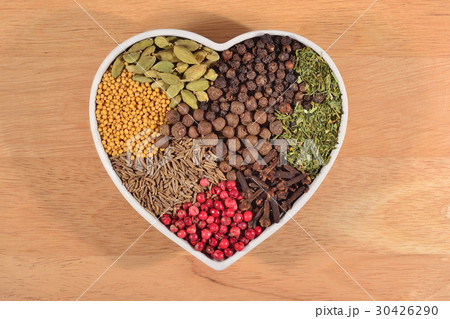 Different dry spices in plate in form of heart 30426290