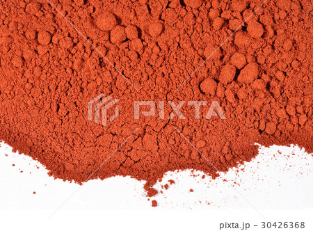 Heap of ground paprika on a white Heap of ground paprika on a white 30426368
