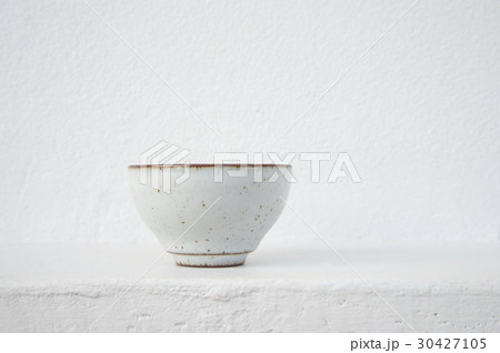 white ceramic tea cup with cement wall background 30427105