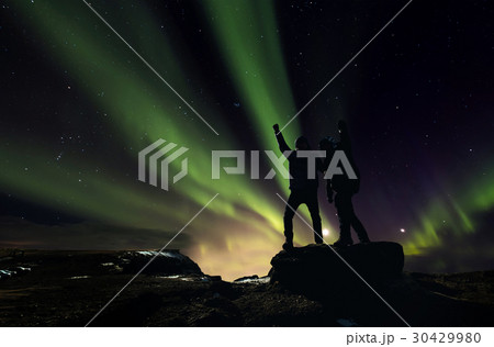 Silhouette men standing with Aurora Borealis 30429980