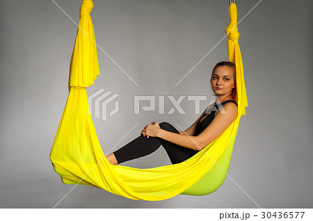 Young woman practicing aero yoga, studio shot. Young woman practicing aero yoga, studio shot. 30436577