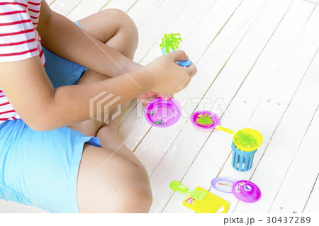 Child Asian playing toy on white wooden.Top view. Child Asian playing toy on white wooden.Top view. 30437289