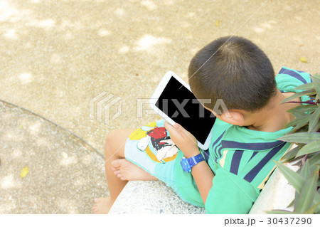 Child Asian using tablet computer in his hand in p Child Asian using tablet computer in his hand in p 30437290