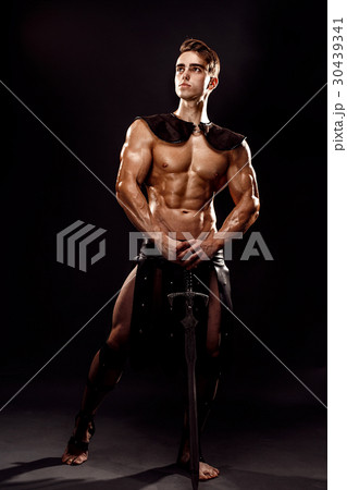 Portrait of handsome muscular gladiator with sword Portrait of handsome muscular gladiator with sword 30439341