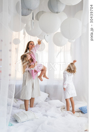 Woman and children on bed 30439704
