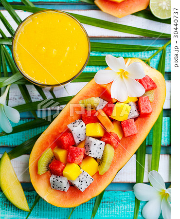 Fruit salad in half of papaya mango juice smoothie 30440737