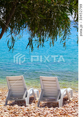 Two deck chairs on beach in sun day Two deck chairs on beach in sun day 30452799