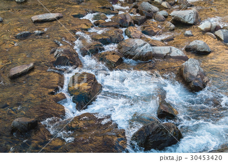 streaming water over the rocks in morning streaming water over the rocks in morning 30453420