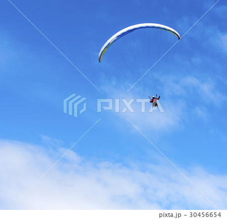 Paraglider flies paraglider in the sky. Paraglider flies paraglider in the sky. 30456654