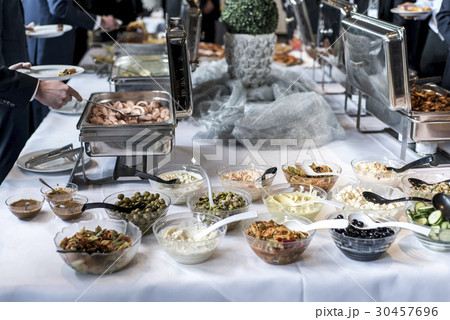 Variety of fresh salads bowls on buffet table 30457696