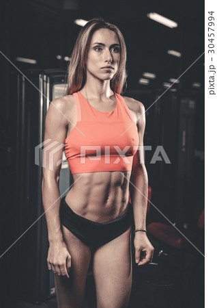 Caucasian sexy fitness female model in gym close up abs. Caucasian sexy fitness female model in gym close up abs. 30457994