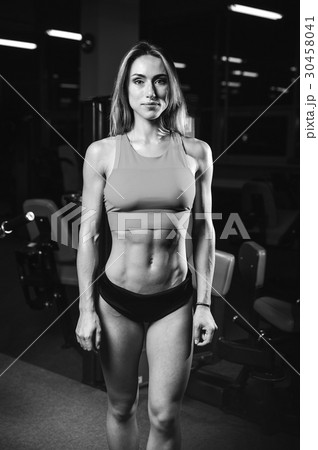 Caucasian sexy fitness female model in gym close up abs. 30458041