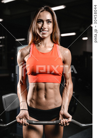 Caucasian pretty fitness girl on diet training pumping up muscle 30458044