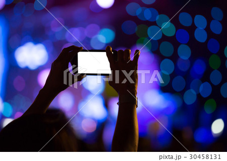 Hand with a smartphone records luxury party 30458131