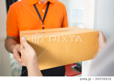Woman accepting a delivery of cardboard boxes 30458928