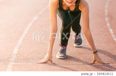 Beautiful athlete on a race track is ready to run. 30461611