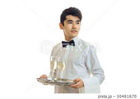 young handsome waiter holding a tray with glasses 30461670