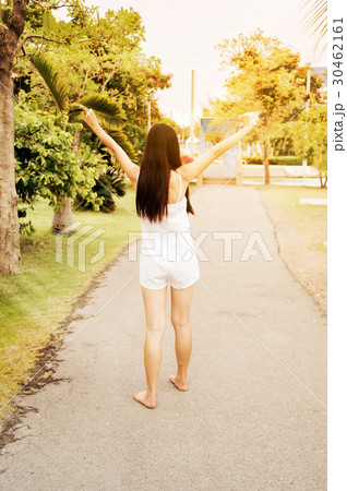 woman enjoying her time outside in public park woman enjoying her time outside in public park 30462161