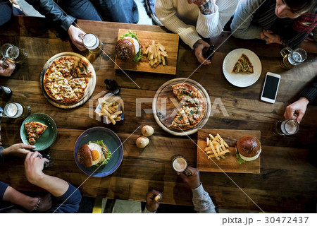 Friends all together at restaurant having meal 30472437