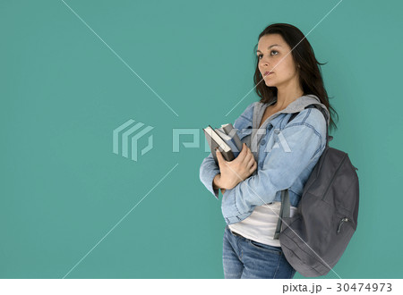 Girl student is carrying books and backpack 30474973