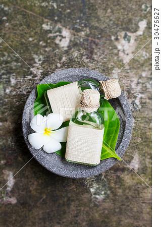 Massage oil on grey wooden background. Top view. 30476627