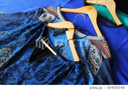Women clothes of blue color on wooden hangers 30480546