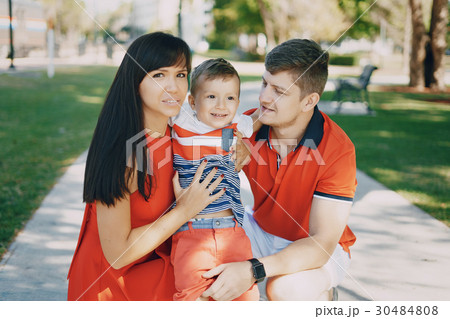 beautiful family in red walking down the street beautiful family in red walking down the street 30484808