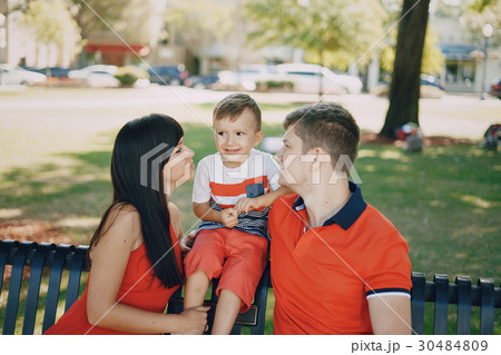 beautiful family in red walking down the street 30484809