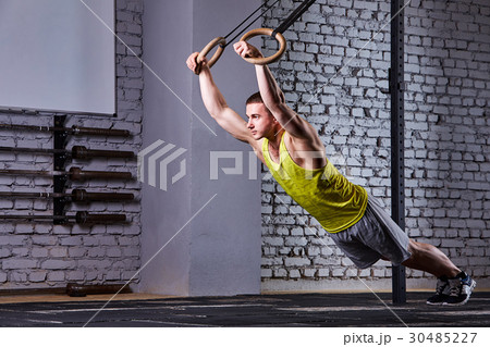 Young athlete man working out in gym pull ups with 30485227