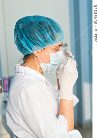 Woman dentist works in the medical dental office. 30488120