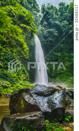 Amazing Nungnung waterfall, Big stone in front Amazing Nungnung waterfall, Big stone in front 30488317
