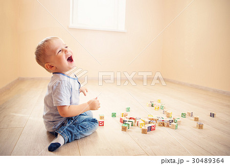 two years old child sitting on the floor with 30489364