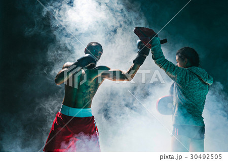 Handsome Afro American boxer with bare torso is 30492505