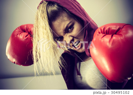 Angry woman wearing boxing gloves Angry woman wearing boxing gloves 30495102