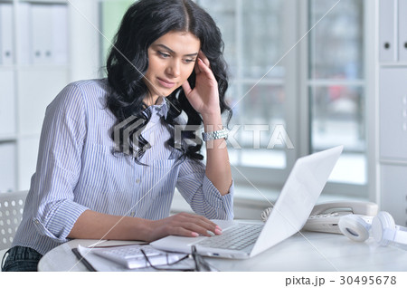 Business woman sitting at table Business woman sitting at table 30495678