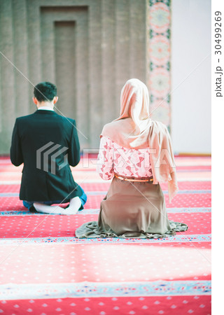 Muslim man and woman praying 30499269